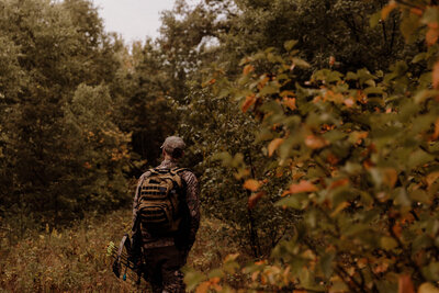 A man walking a trail in the fall woods of southern Wisconsin