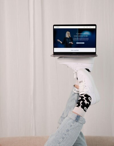 maiju balancing laptop on top of her feet 