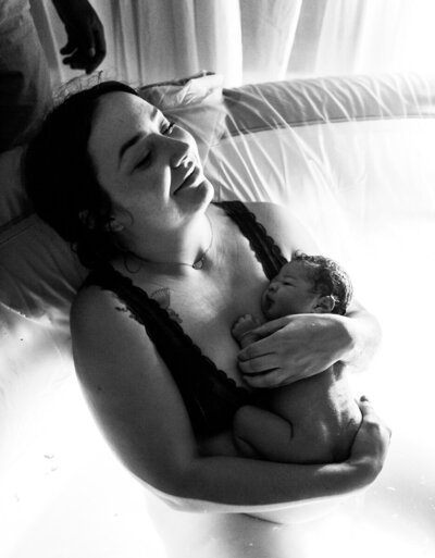 Birth Photograph of mom after having baby in water at home