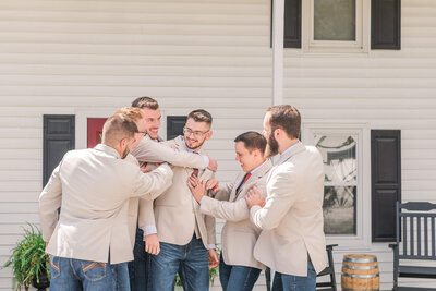 Bride and groom share a first look  on a wooden dock by a forest lake at a southwestern Pennsylvania wedding venue