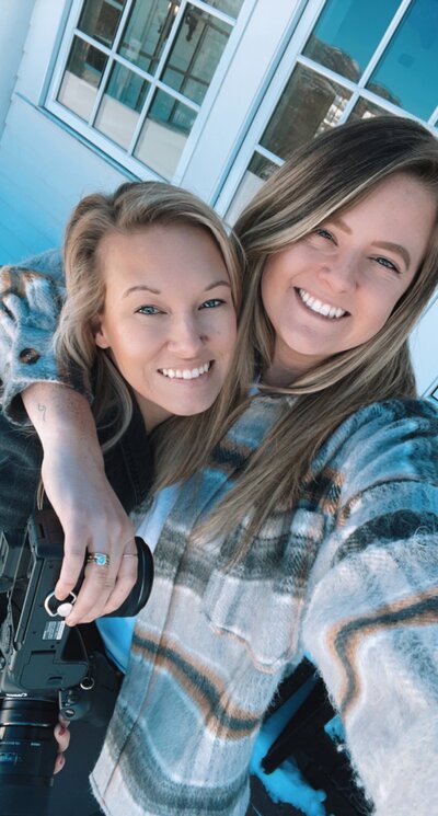 Rachel and Lauren smiling in a garden during a break from a shoot.