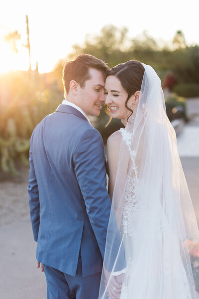 Bride and groom kissing in the forest