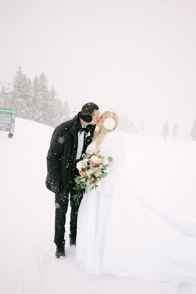 Bride and groom kissing at destination wedding in Vail, Colorado.