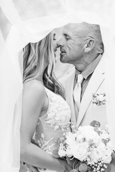 bride and groom kissing at a vineyard