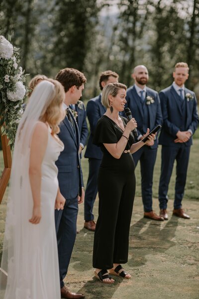 Wedding officiant speaking into microphone