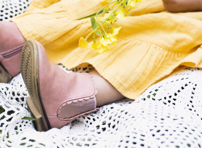 Little girls feet, pink shoes and a yellow dress.  Lifestyle Photography.