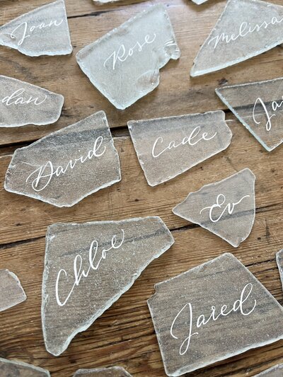 Sea glass place cards with white ink calligraphy