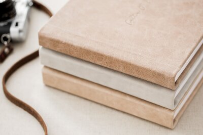 sstack of leather wedding albums