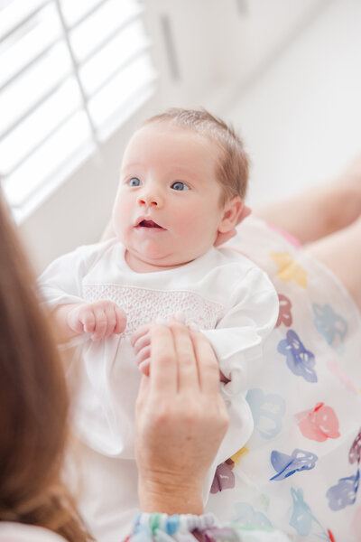 Portrait of newborn baby in  mother's hands.-Newborn Photography Greenville SC