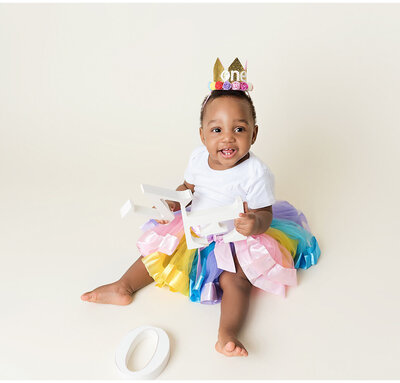 A cake smash session capturing the pure joy and fun of a child's first birthday.