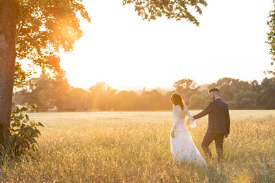 Bride and Groom in arch at night at Rockbeare Manor wedding venue in Devon