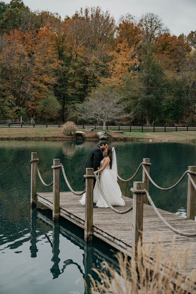 Groom & bride share unscripted moment with Nashville wedding videographer on a dock