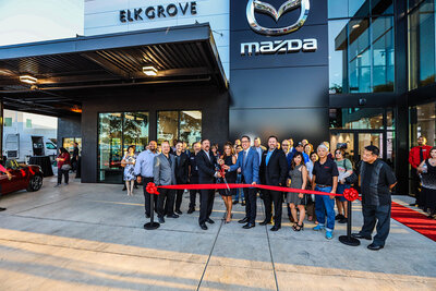People cutting a red ribbon in front of a car dealership, captured by sacramento photography studio philippe studio pro.