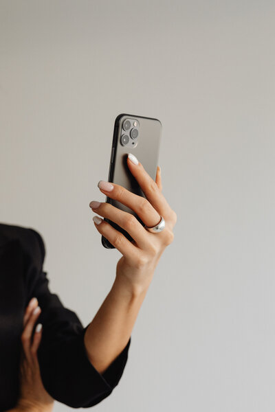 Woman wearing ring holding iphone