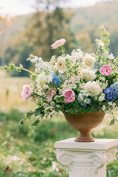 A beautiful display of bright pink, green, white, and blue wedding flowers at a luxury wedding in the carolinas.