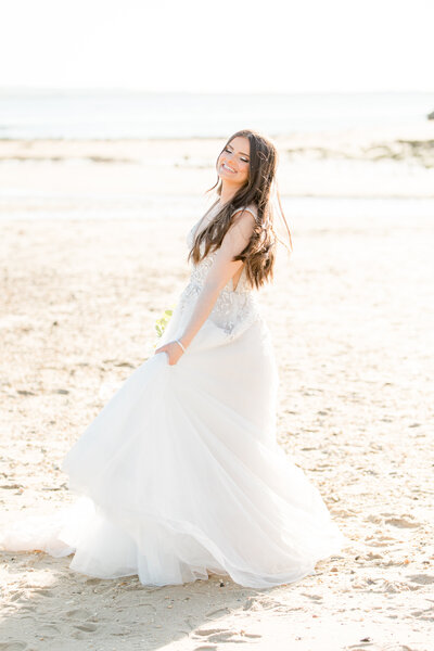 Bride twirling on the NJ beach in wedding gown