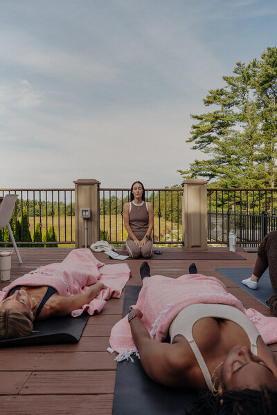 kat smiling with black jacket on shoulders