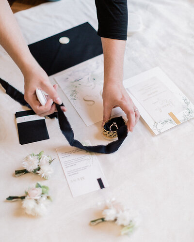 Andreea Bucur - creative director's hands styling a wedding flatlay
