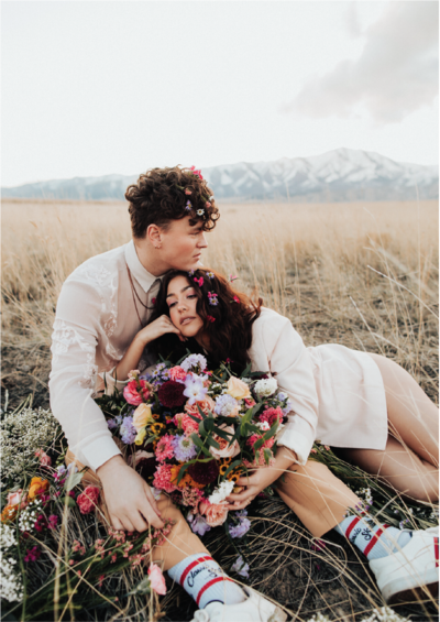 couple-with-flowers-in-mountains