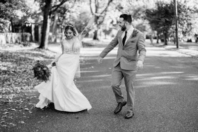 bride and groom dancing in the street
