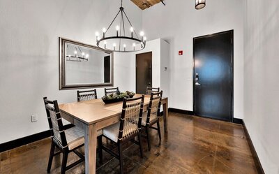 Dining room with seating for six in this three-bedroom, two-bathroom vacation rental condo in the historic Behrens building in downtown Waco, TX.