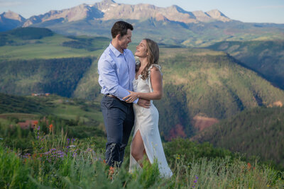 Telluride Engagement on Last Dollar Road, Couple on Last Dollar Road in Telluride by fence, spring engagement