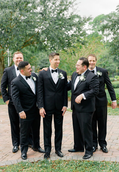 candid groomsmen photo at sprengergarten wedding venue melbourne florida
