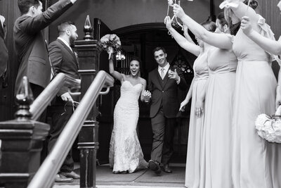 An Ohio groom and a bride happily cheer and celebrate as they walk down the aisle after their wedding ceremony. Photographed by Aaron Aldhizer