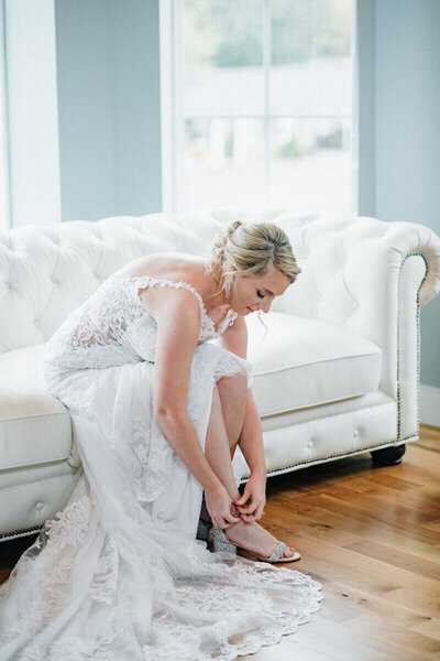 Bride putting on shoes at the Blanford House by wedding photographers lexington ky