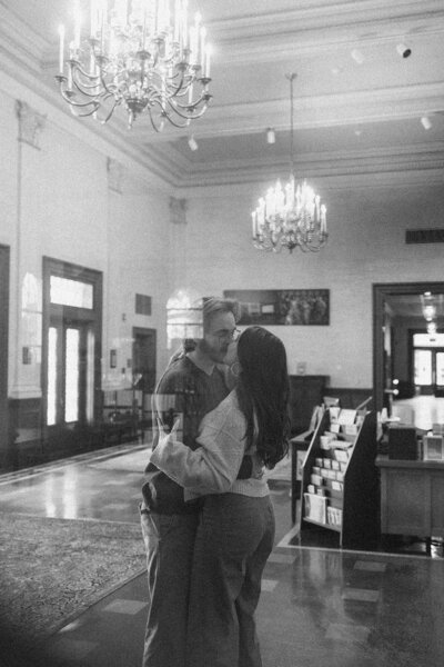 A couple kiss during their engagement session at the Austin History Center