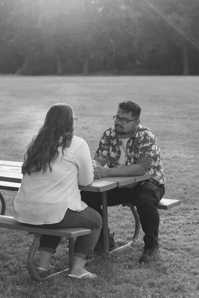 cinematic couple on a park bench