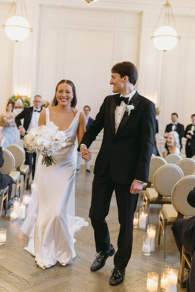 Bride and Groom walking down the aisle happily married at their stunning wedding designed and planned by Everlasting Events