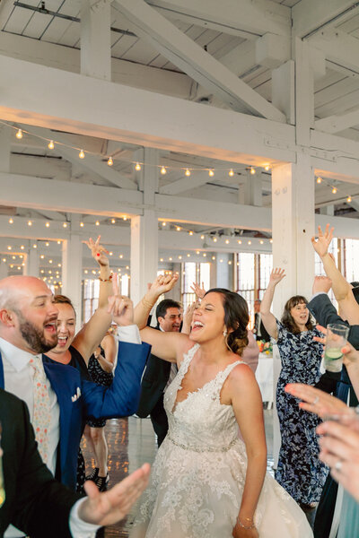 Candid moment of the couple dancing with their guests at The Cracker Factory in Geneva, NY.