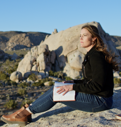 Allie Marie Smith, writing in her journal on the beach