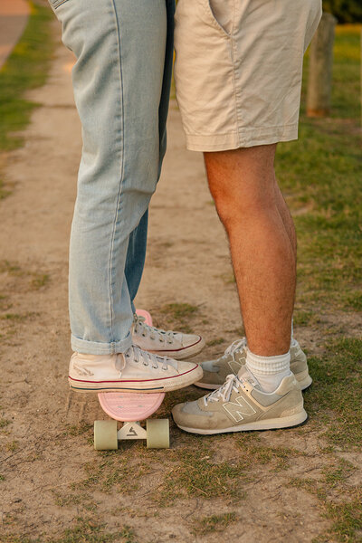 couple posing with skateboard for couples session in dallas texas