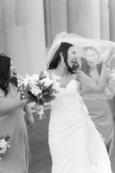 bride laughing with sisters on wedding day portraits at the Nelson-Atkins Museum