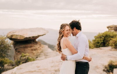 Bride and groom sharing an embrace at their mountaintop wedding