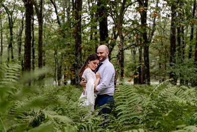 couple standing in trees