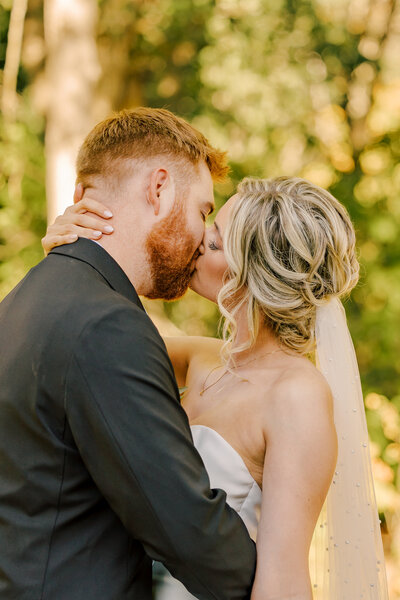 The bride and groom kissing.