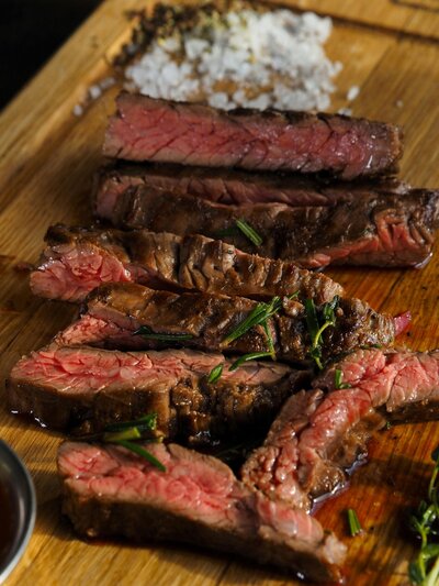 Juicy, perfectly cooked steak served with a rich, flavorful herb butter and grilled to perfection, showcasing the true essence of Texas dining.
