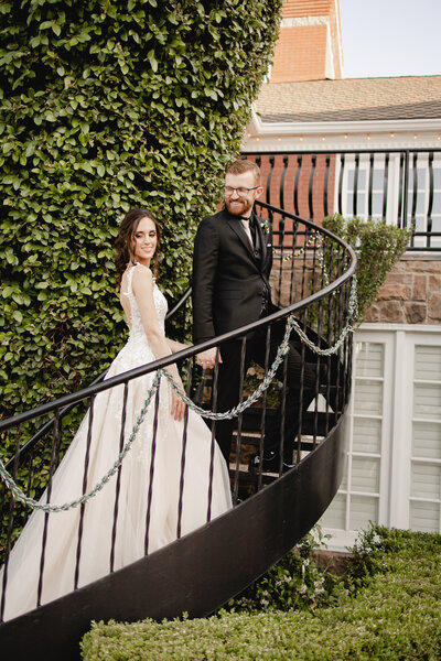 couple walking up stairs at stonebridge manor on their wedding day