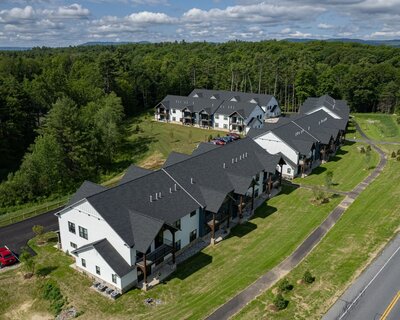 View from above of apartment buildings with asphalt shingles roofs