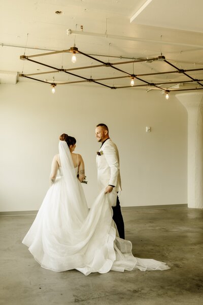 Bride and groom talking in minimalist venue.