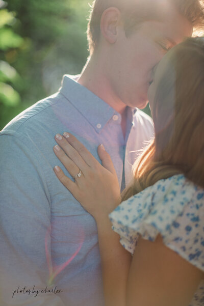 an engaged couple kissing