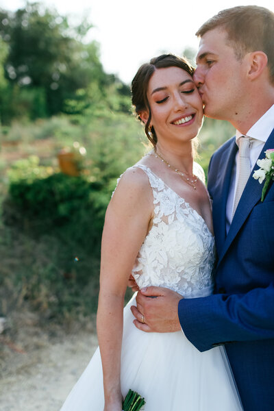 groom-kissing-bride-at-luxury-destination-wedding-in-provence-leslie-choucard-photography