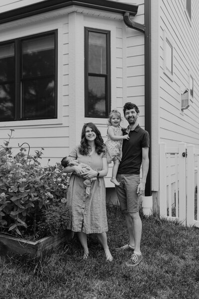 Black and white image of family in their garden, photographed by Jacoby Andrick