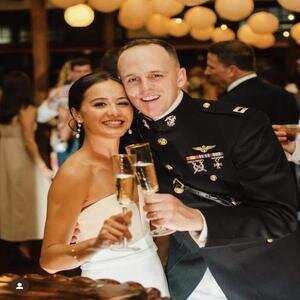 Palafox Wharf:  Pensacola wedding venue on the waterfront showing bride and groom in her white wedding dress and he is in dark military uniform.