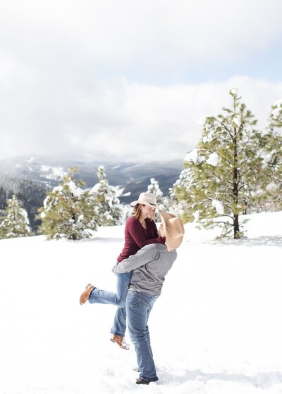 Playful couple at their engagement session at Mt. Falcon Trailhead in Indian Hills.