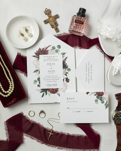 flat lay of details from a burgundy themed wedding