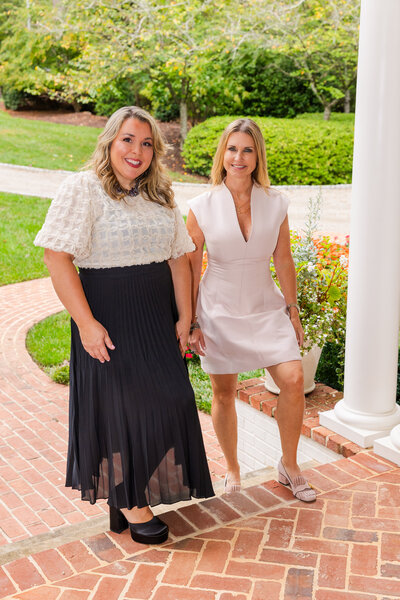 real estate agent women team on patio stairs walking toward a house front door in Atlanta by Laure Photography